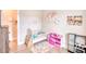 Bedroom featuring a crib, a play kitchen, and colorful decor for a playful and inviting ambiance at 3508 Cox Cemetery Rd, Social Circle, GA 30025