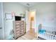 This Bedroom has a dresser with a TV, a crib and simple decor creating a cozy atmosphere at 3508 Cox Cemetery Rd, Social Circle, GA 30025