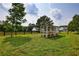 Coop in the grassy backyard with perimeter fencing in a lush, green setting at 3508 Cox Cemetery Rd, Social Circle, GA 30025