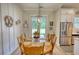 Open dining area with elegant decor, hardwood floors, and backyard views at 3508 Cox Cemetery Rd, Social Circle, GA 30025