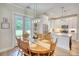 Bright dining area with wood table, backyard views, and access to the kitchen at 3508 Cox Cemetery Rd, Social Circle, GA 30025