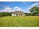 Beautiful white farmhouse with covered front porch and manicured front lawn on a sunny day at 3508 Cox Cemetery Rd, Social Circle, GA 30025