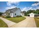 Side view of a sprawling home with a detached garage and portico on a lush green lawn and blue sky at 3508 Cox Cemetery Rd, Social Circle, GA 30025
