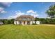 A sprawling home with a long driveway, a detached garage with a portico, and a large grassy front yard at 3508 Cox Cemetery Rd, Social Circle, GA 30025