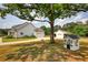 The back yard is complete with a playhouse and tree swing next to the detached garage with portico at 3508 Cox Cemetery Rd, Social Circle, GA 30025