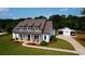 Beautiful, modern farmhouse-style home with a well-manicured lawn and separate garage at 3508 Cox Cemetery Rd, Social Circle, GA 30025