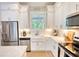 Modern kitchen with white cabinetry, stainless steel appliances, and sleek countertops at 3508 Cox Cemetery Rd, Social Circle, GA 30025