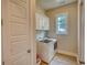 Laundry room with ample storage, stainless steel appliances, and natural light at 3508 Cox Cemetery Rd, Social Circle, GA 30025