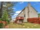 Exterior view of the house featuring a wooden deck and a fenced-in backyard at 3943 Alexandra Oak Ct, Suwanee, GA 30024