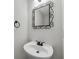 Powder room with decorative mirror above the modern vanity at 3943 Alexandra Oak Ct, Suwanee, GA 30024