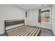 Bedroom features a minimalist platform bed frame and a well-lit window at 3943 Alexandra Oak Ct, Suwanee, GA 30024