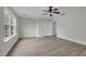 Spacious bedroom features a ceiling fan, natural light, and modern flooring at 3943 Alexandra Oak Ct, Suwanee, GA 30024
