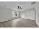 Bedroom has grey vinyl flooring, bright windows and a ceiling fan at 3943 Alexandra Oak Ct, Suwanee, GA 30024