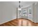 Dining room with hardwood floors, natural light, and a modern chandelier at 3943 Alexandra Oak Ct, Suwanee, GA 30024