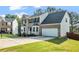 Traditional two-story home with brick and siding, a well-manicured lawn, and a driveway at 3943 Alexandra Oak Ct, Suwanee, GA 30024