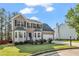 Classic two-story home with a brick front, bay windows, and an attached two-car garage at 3943 Alexandra Oak Ct, Suwanee, GA 30024