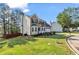 Suburban two-story home with a green lawn, landscaping, and neutral siding at 3943 Alexandra Oak Ct, Suwanee, GA 30024