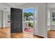 Bright foyer with hardwood floors, a view of the front yard, and natural light at 3943 Alexandra Oak Ct, Suwanee, GA 30024