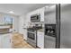 Well-lit kitchen featuring stainless steel appliances, granite counters and white cabinets at 3943 Alexandra Oak Ct, Suwanee, GA 30024