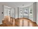 Open living space featuring hardwood floors, neutral walls, and bay windows at 3943 Alexandra Oak Ct, Suwanee, GA 30024