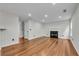 Open-concept living room with hardwood floors and fireplace at 3943 Alexandra Oak Ct, Suwanee, GA 30024