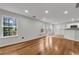 Bright living area with hardwood floors that seamlessly blends with the kitchen at 3943 Alexandra Oak Ct, Suwanee, GA 30024