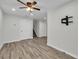 Versatile area with ceiling fan transitions to a room with stairs and natural light at 3943 Alexandra Oak Ct, Suwanee, GA 30024