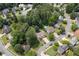 An aerial view shows the layout of the neighborhood with mature trees and winding streets at 503 Silver Maple Ln, Woodstock, GA 30189