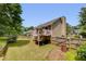A large, well-maintained backyard features a deck and tall trees at 503 Silver Maple Ln, Woodstock, GA 30189