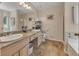 Bright bathroom featuring double sinks, tile floors, and a separate shower and tub at 503 Silver Maple Ln, Woodstock, GA 30189