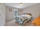 Comfortable bedroom with a window view and cozy quilt, perfect for relaxation at 503 Silver Maple Ln, Woodstock, GA 30189