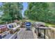 Outdoor deck with cozy seating, BBQ grill, and wooded view for entertaining at 503 Silver Maple Ln, Woodstock, GA 30189