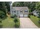 Traditional two-story home with two-car garage, well manicured lawn and lush trees at 503 Silver Maple Ln, Woodstock, GA 30189