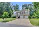 Traditional home with a two car garage, lush green lawn and mature trees in a suburban setting at 503 Silver Maple Ln, Woodstock, GA 30189