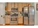 Kitchen with stainless steel appliances and light wood cabinets at 503 Silver Maple Ln, Woodstock, GA 30189
