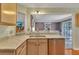 Kitchen view with stone countertops, stainless dishwasher, and breakfast bar opening to the dining room at 503 Silver Maple Ln, Woodstock, GA 30189