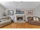 A stone fireplace is the focal point of this living room complete with hardwood floors and neutral paint at 503 Silver Maple Ln, Woodstock, GA 30189