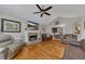 Bright living room featuring a stone fireplace, hardwood floors and a large TV above the mantle at 503 Silver Maple Ln, Woodstock, GA 30189