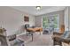Home office with natural light, comfortable seating, and space for exercise equipment at 503 Silver Maple Ln, Woodstock, GA 30189