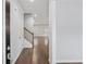 Inviting home entryway showcasing hardwood floors, staircase with rod iron railing, and neutral paint at 6104 Marigold Way, Atlanta, GA 30349