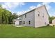 Rear exterior view of a two-story home featuring siding, brick, and a covered patio at 6104 Marigold Way, Atlanta, GA 30349