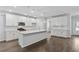 Modern kitchen featuring white cabinets, quartz countertops, stainless steel appliances, and a large island at 6104 Marigold Way, Atlanta, GA 30349