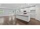Bright, open-concept kitchen featuring an island with quartz countertops and modern pendant lighting at 6104 Marigold Way, Atlanta, GA 30349