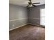 This is a carpeted bedroom with a ceiling fan and natural light from the window at 861 Creek Trail Nw, Kennesaw, GA 30144