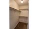 Walk-in closet with shelving on three walls and carpeted flooring at 861 Creek Trail Nw, Kennesaw, GA 30144