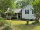 Quaint home featuring well-manicured landscaping, a covered porch and a green lawn at 861 Creek Trail Nw, Kennesaw, GA 30144
