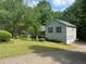 Home featuring an attached garage, lush green lawn, and mature trees at 861 Creek Trail Nw, Kennesaw, GA 30144