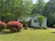 Charming home with lush lawn, mature trees, and colorful shrubs at 861 Creek Trail Nw, Kennesaw, GA 30144
