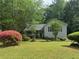 Cozy home with beautiful landscaping, green lawn and mature trees at 861 Creek Trail Nw, Kennesaw, GA 30144
