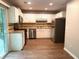 Well-lit kitchen featuring white cabinets, stainless steel appliances, and wood-look flooring at 861 Creek Trail Nw, Kennesaw, GA 30144